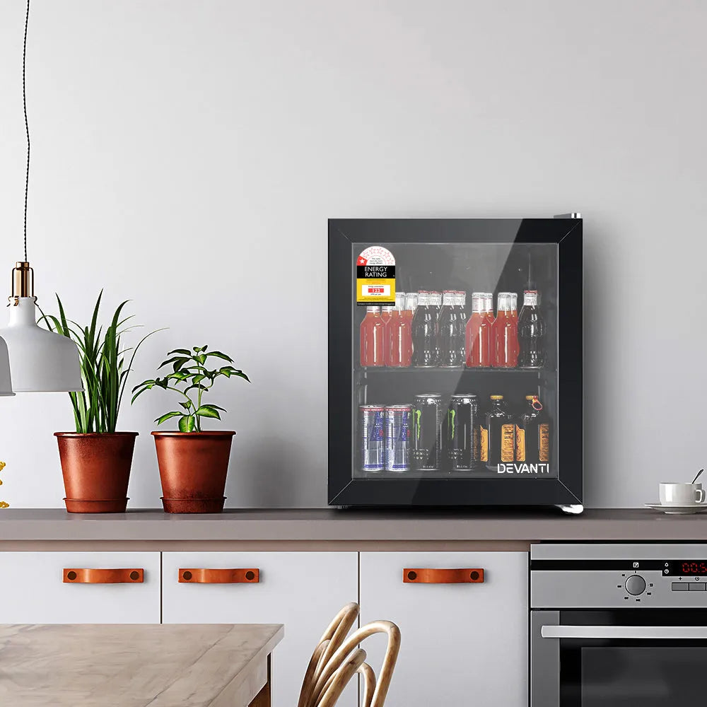 Modern kitchen with a Devanti wine cooler on a countertop, surrounded by potted plants and kitchen appliances.